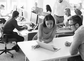 Team members collaborating in a modern office meeting room.